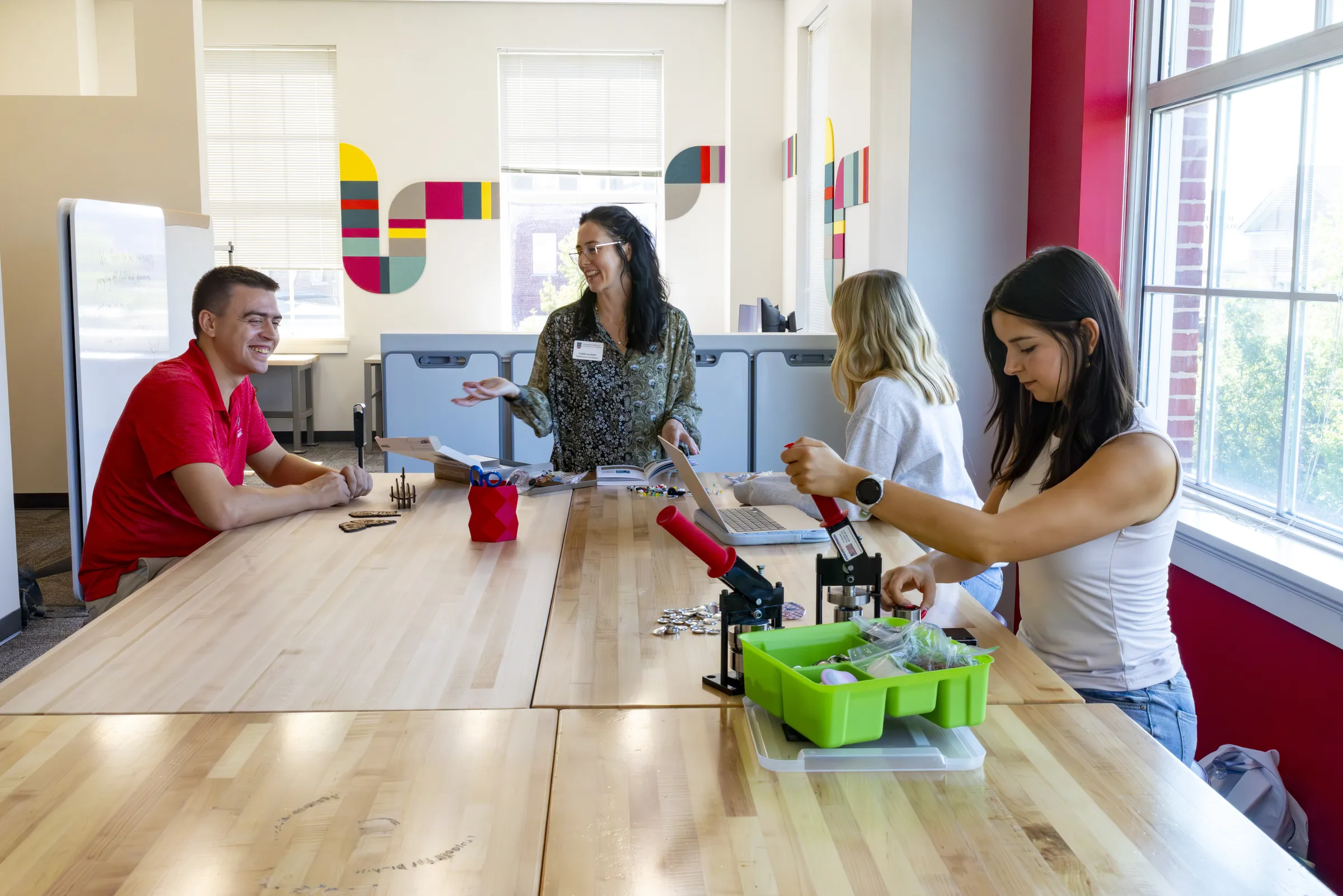 Students sitting together at a large table in the Creative Engagement Wing of the Miller Learning Center.